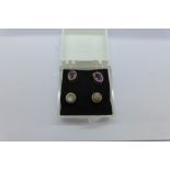 A pair of 9ct gold and amethyst ear studs and a pair of moonstone set ear studs