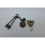 A Victorian skirt lifter and a chatelaine hook with compass fitted