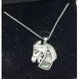 A silver horse's head pendant and chain