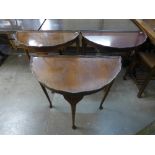 Three walnut demi-lune hall tables