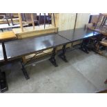 A pair of wrought iron based pub tables