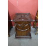 A carved mahogany pedestal