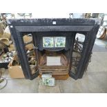 An Art Nouveau style cast iron and tiled fire surround