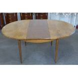 A G-Plan teak circular extending dining table