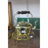 A brass and copper kettle with stand