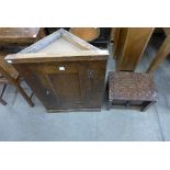An oak wall hanging corner cupboard and an oak and leather topped box