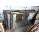 A gilt mirror and walnut effect mirror