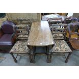 An oak drop-leaf table and four chairs