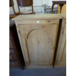 A pine single door cupboard