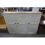 A painted pine three door school cupboard