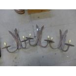 A set of three French wrought iron wall sconces