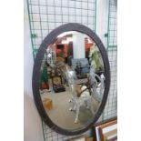 An Arts and Crafts hammered pewter mirror