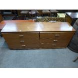 A pair of teak chests of drawers