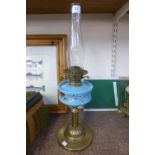 A Victorian brass and porcelain oil lamp