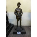 A bronze figure of a workman