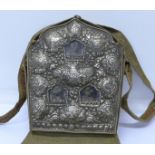 A Tibetan ghau or prayer bag with eleven good luck symbols in white metal and three Buddha