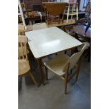 A 1950's Formica draw-leaf table and two chairs