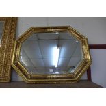 An octagonal gilt framed mirror