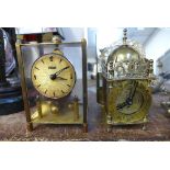 A small brass lantern timepiece and anniversary timepiece