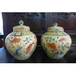 A pair of Chinese famille rose vases and covers