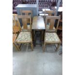 An oak drop-leaf table and four chairs