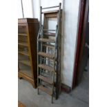 A set of pine stepladders and a tubular steel ladder