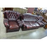 A Chesterfield red leather settee and pair of armchairs