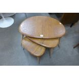 An Ercol pebble shaped nest of tables