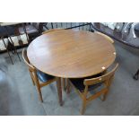 A teak extending dining table and four Danish teak chairs