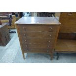 A teak chest of drawers