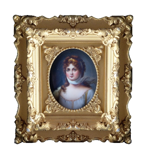 An early 19th Century portrait miniature of a lady, oval quarter length, on porcelain, 8.