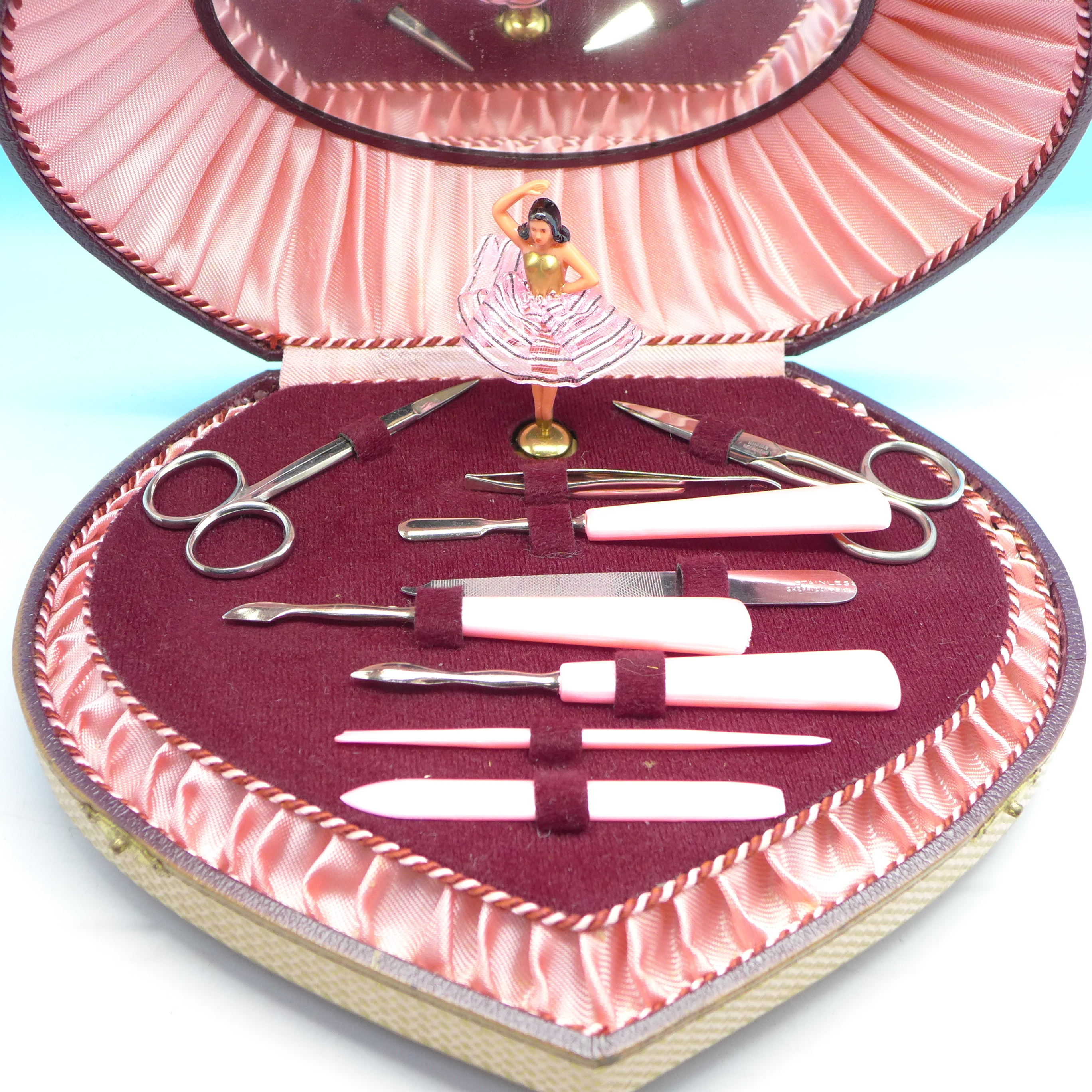 A cased musical manicure set