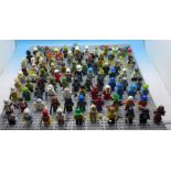 A collection of approximately 100 mini figures including Lego