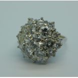 An 18ct white gold nineteen stone diamond cluster ring, centre diamond 0.65 carat, six 0.