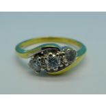 An 18ct gold, three stone diamond crossover ring, stamped 0.50ct, 4.