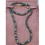 A black cultured pearl necklace and bracelet