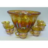 A carnival glass punch bowl with eleven cups (12)