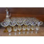 A set of seven liqueur glasses, a decanter with gilded decoration and seventeen champagne coupes,