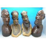 Two pairs of carved African busts,
