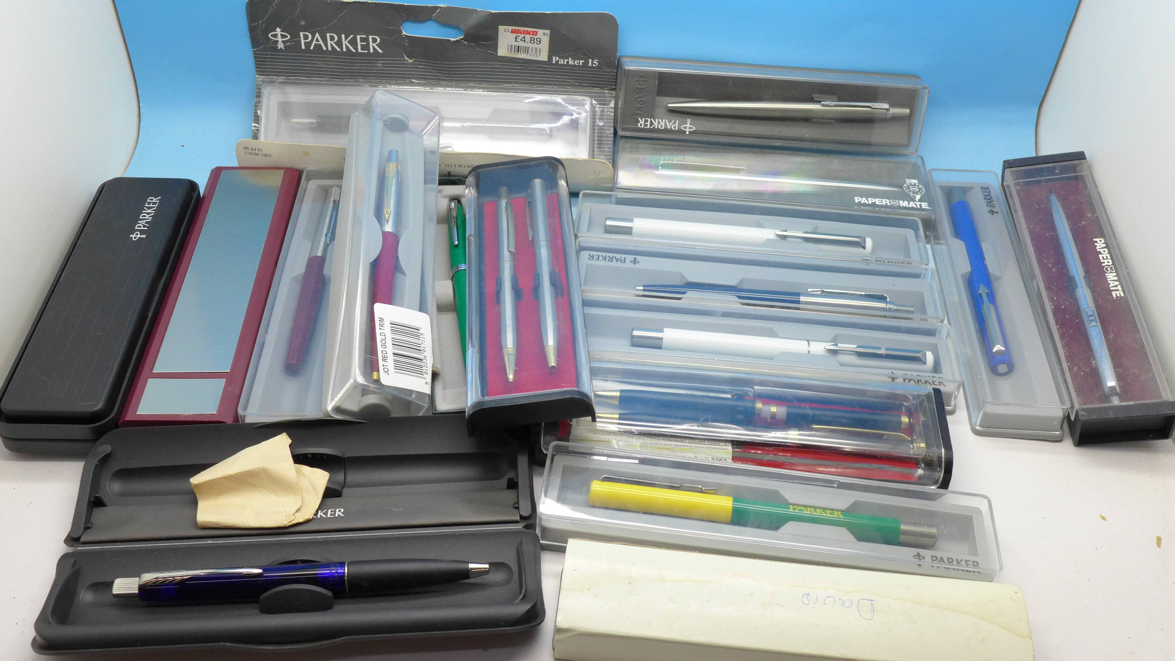 A collection of pens including Parker and Cross