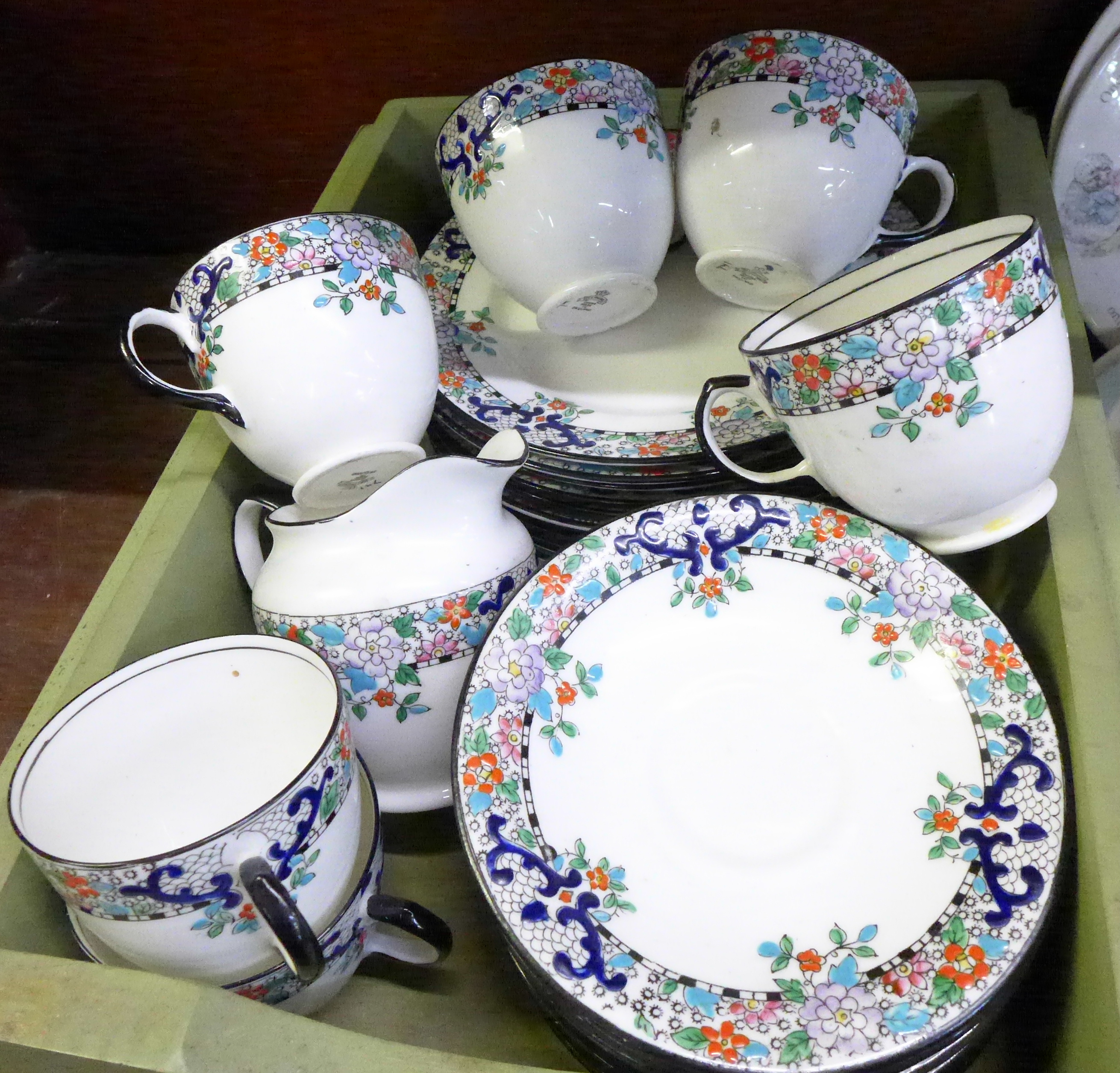 A Delphine china tea service; six cups, ten saucers, ten medium plates,