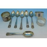 Three silver napkin rings and six silver teaspoons (5+1),