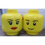 Two Lego 'head' storage boxes with a collection of Lego