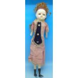 A Victorian doll with waxed head and glass eyes, wooden arms and legs,