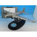 A Franklin Mint B-179 Flying Fortress with papers and stand