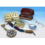 A bead purse, faux tortoiseshell glasses, a brass stamp box, etc.