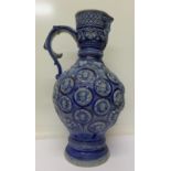 A large German ewer with face spout and roundels,