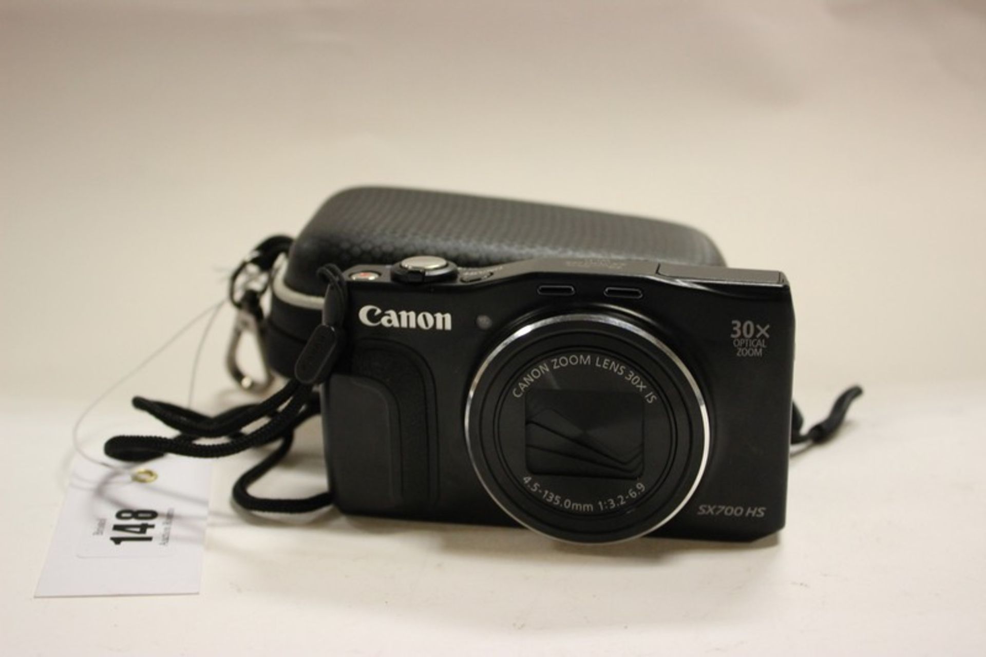 A Canon SX700 HS camera in case.