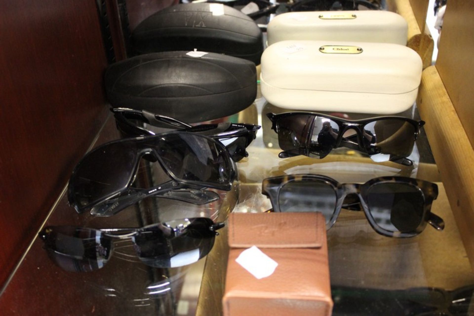 Eight pairs of branded sunglasses.