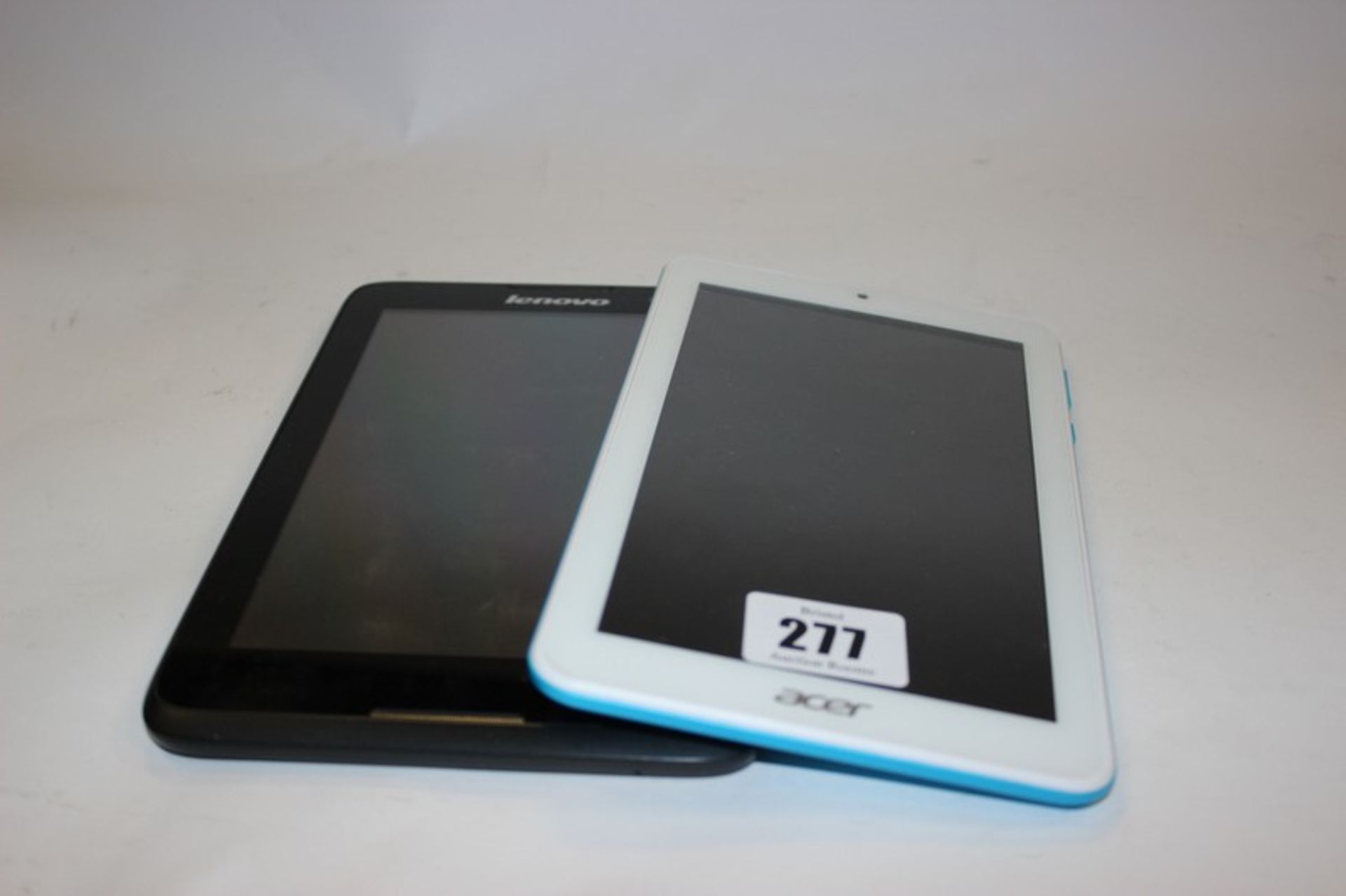 An Acer Iconia One tablet model: A5007 and a Lenovo A3500-FL tablet.